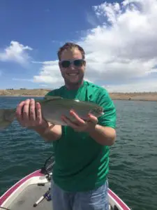 Image of angler holding up a rainbow trout caught at starvation reservoir